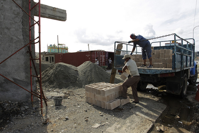 Trabajadores descargan materiales para la reconstrucción de un edificio afectado por el huracán Matthew, en el malecón de la histórica ciudad de Baracoa, en la oriental provincia Guantánamo, en Cuba. Crédito: Jorge Luis Baños/IPS