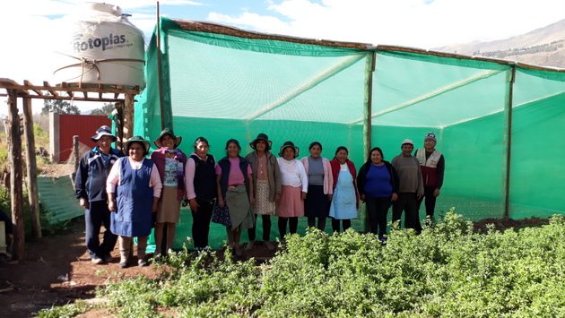Campesinas de la comunidad de Huasao, en las altiplanicies andinas de Cusco, en Perú, delante de uno de los fitotoldos de 50 metros cuadrados, que cuentan con un tanque de 750 litros de agua para el módulo de riego tecnificado por goteo de las hortalizas. Crédito: Mariela Jara/IPS