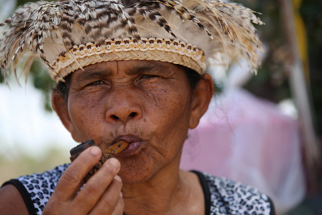 La cacica Dorinha Tuxá canta a su sagrado río y fuma su “marakú”, una pipa con tabaco e hierbas rituales, para pedir a sus ancestros que les ayuden a que les entreguen las tierras comprometidas, cuando los desalojaron de su isla fluvial en el río São Francisco para construir una represa en el nordeste de Brasil. Crédito: Gonzalo Gaudenzi/IPS